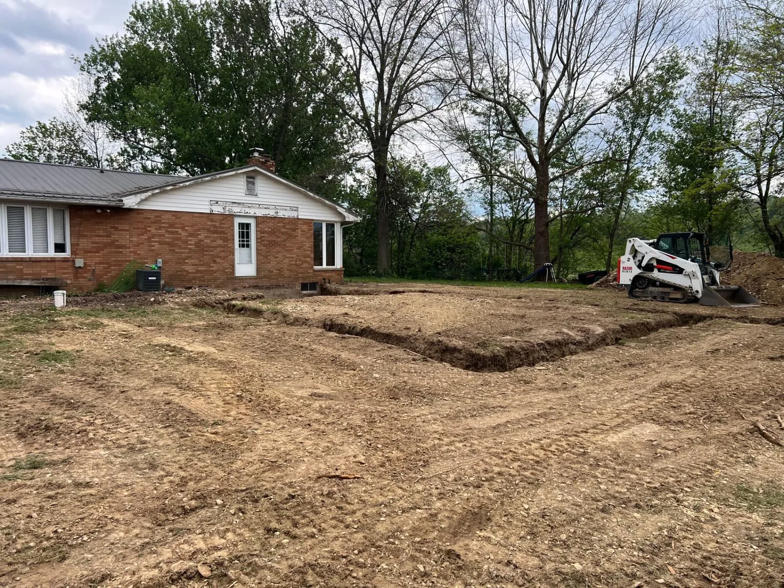 Site excavation with skid steer