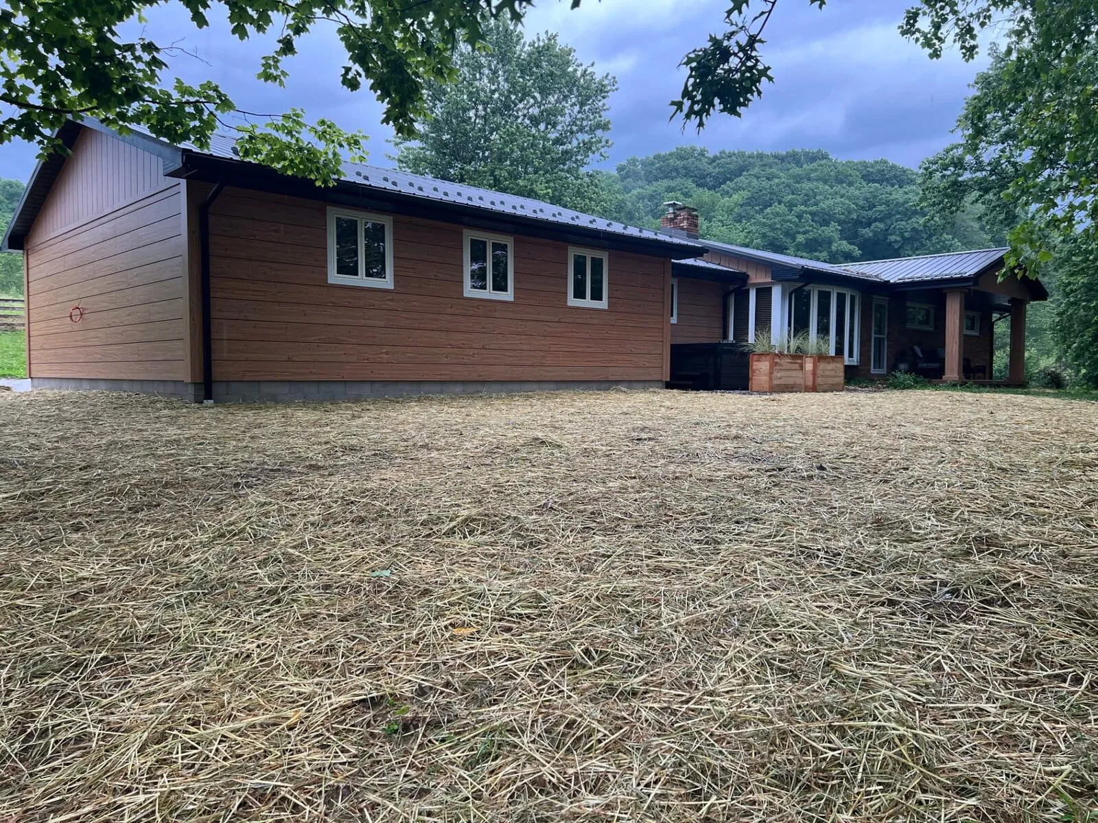 Wood-sided home with new metal roof